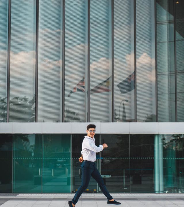 Man jumping on pavement of highrise