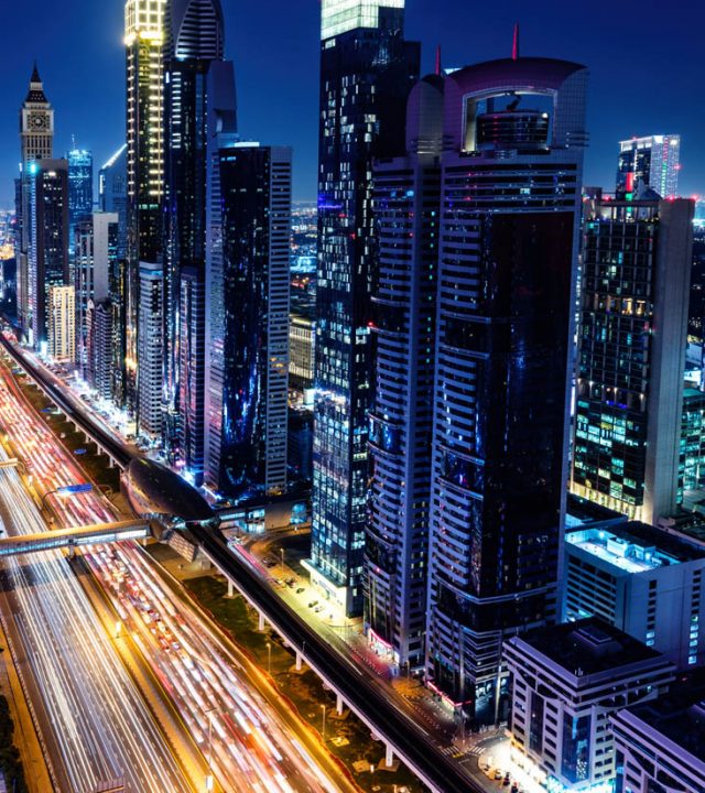 Skyscrapers highrise business buildings in downtown Dubai, UAE at night